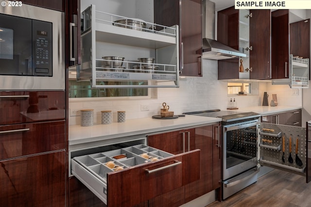 kitchen featuring built in microwave, stainless steel electric range oven, dark hardwood / wood-style floors, dark brown cabinets, and wall chimney range hood