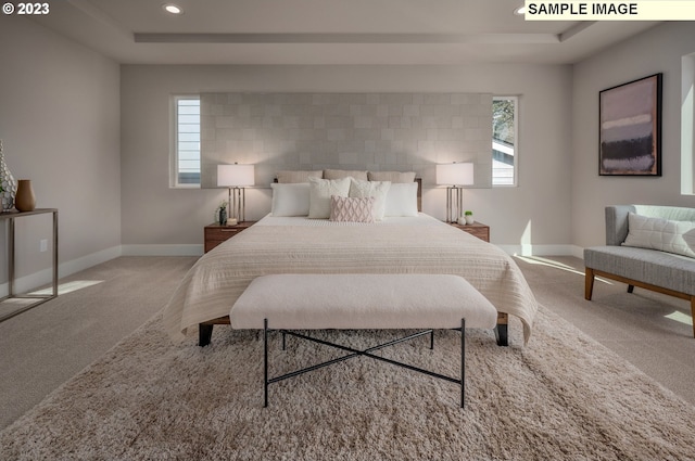 bedroom featuring a raised ceiling and carpet floors