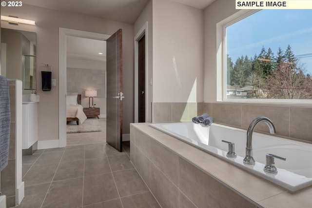 bathroom featuring tiled bath and tile patterned flooring