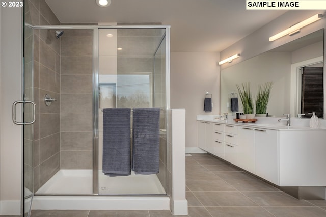 bathroom featuring vanity, tile patterned floors, and a shower with shower door