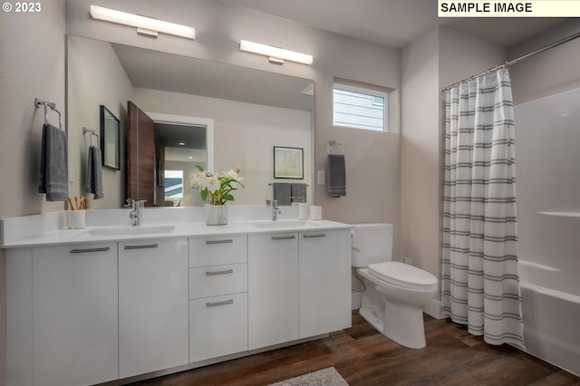 full bathroom with toilet, hardwood / wood-style flooring, shower / tub combo, and vanity