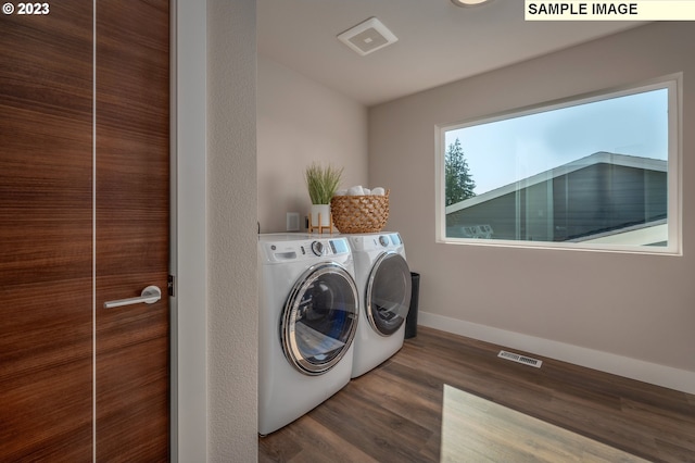 washroom featuring dark wood-type flooring and washing machine and dryer