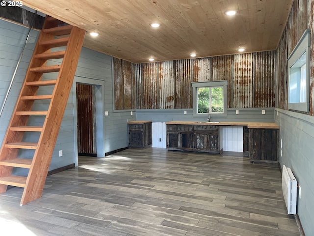 bar with a sink, recessed lighting, wood ceiling, and wood finished floors