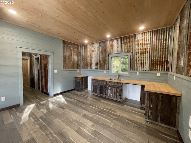 kitchen featuring wood finished floors, recessed lighting, a sink, butcher block countertops, and wood ceiling