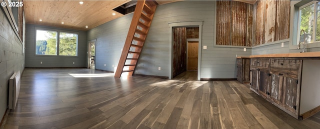 interior space featuring recessed lighting, radiator, wooden ceiling, wood walls, and dark wood-style flooring