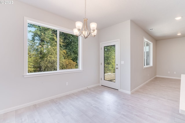 interior space with a notable chandelier and light hardwood / wood-style flooring