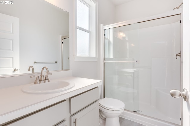 bathroom featuring vanity, an enclosed shower, and toilet