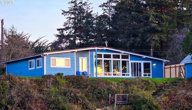 rear view of property with fence
