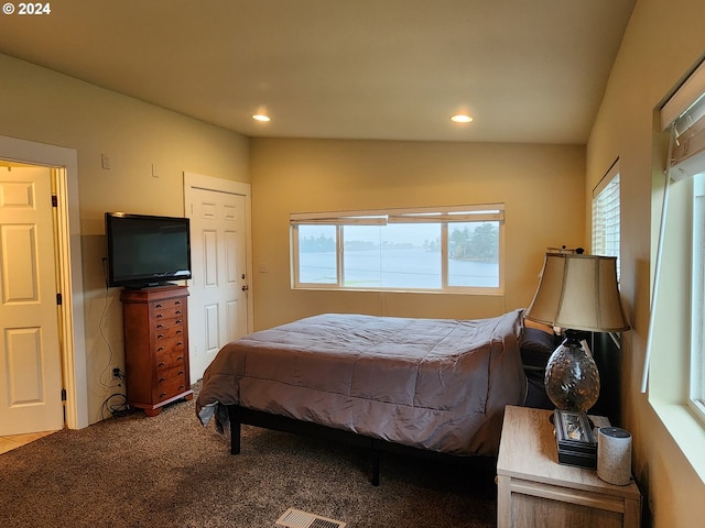 carpeted bedroom featuring multiple windows, visible vents, and recessed lighting