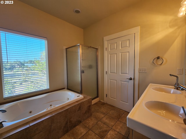 full bath with tile patterned floors, a whirlpool tub, a shower stall, and a sink