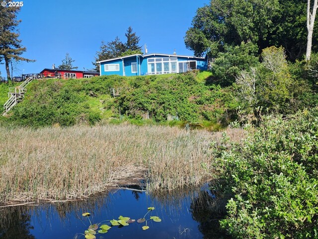 rear view of property with a water view