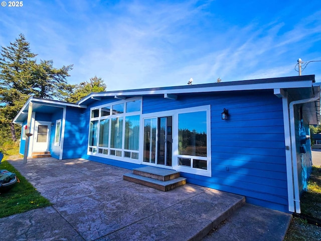 rear view of property featuring a patio area