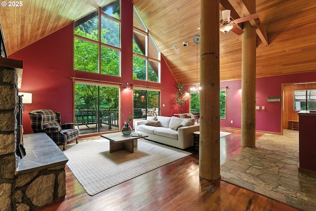 25901 E Highview Dr, Welches, OR 97067 - living room featuring high vaulted ceiling, decorative columns, wood finished floors, a wooden ceiling with exposed beams, and a ceiling fan