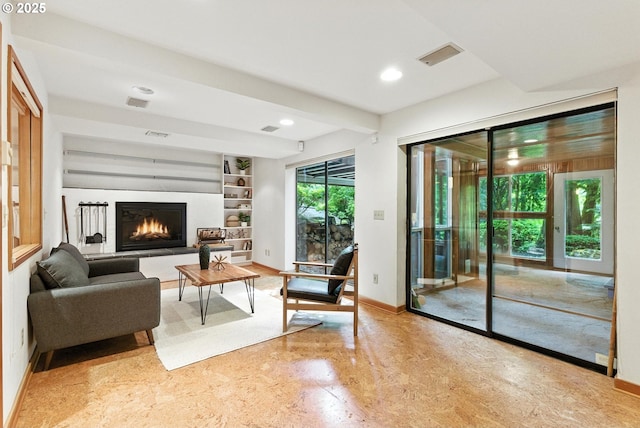 25901 E Highview Dr, Welches, OR 97067 - living room featuring a warm lit fireplace, built in shelves, and recessed lighting