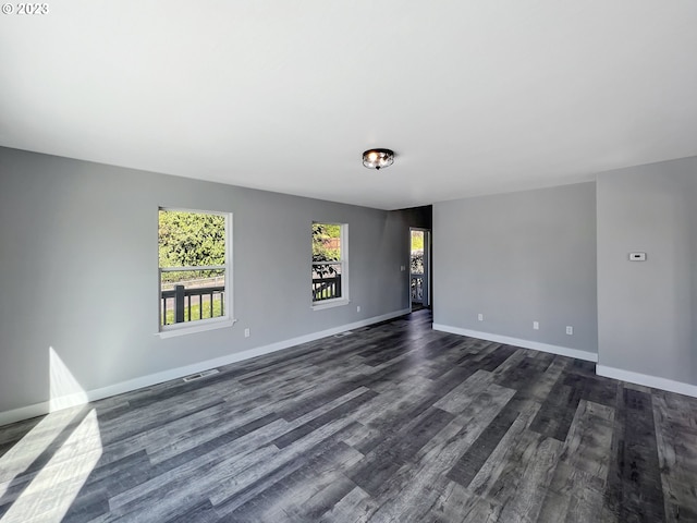 spare room with dark hardwood / wood-style flooring