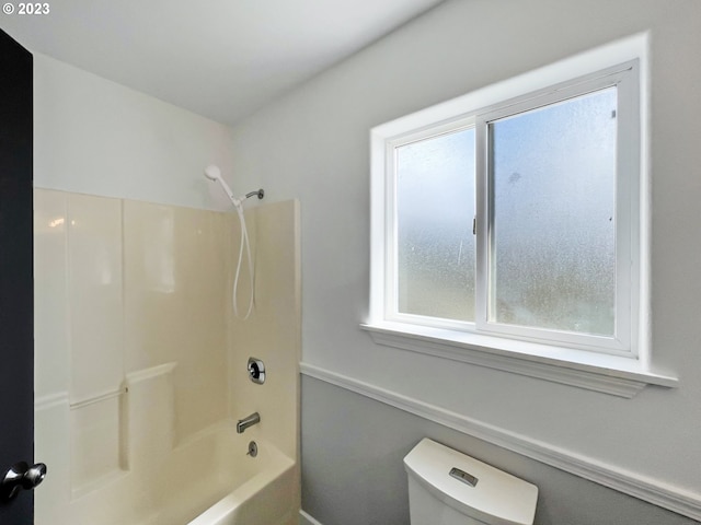 bathroom featuring toilet and shower / bath combination