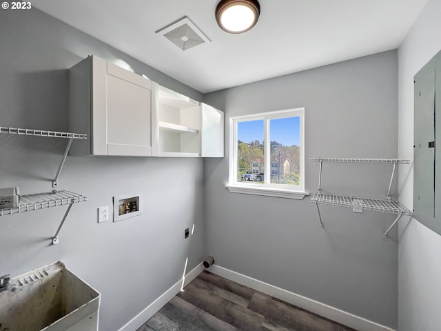 laundry area featuring hookup for a washing machine, electric dryer hookup, dark wood-type flooring, and cabinets