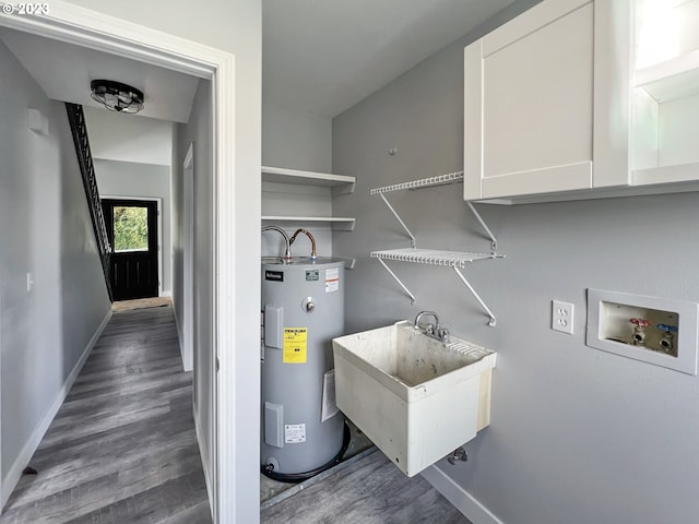 laundry area featuring washer hookup, water heater, dark wood-type flooring, and sink