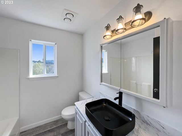 full bathroom with shower / bath combination, toilet, hardwood / wood-style floors, and vanity