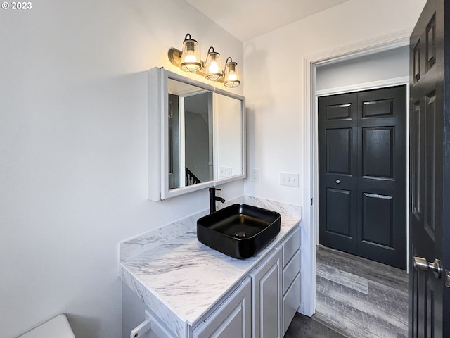 bathroom with vanity and hardwood / wood-style flooring