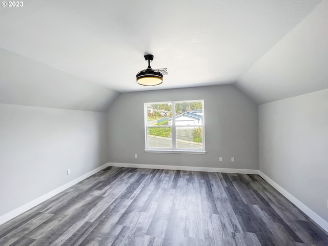 bonus room with lofted ceiling and dark hardwood / wood-style floors