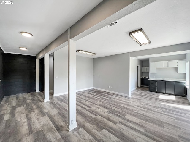 basement with light hardwood / wood-style floors