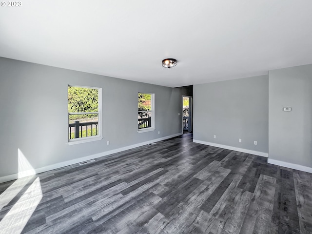 empty room with dark wood-type flooring