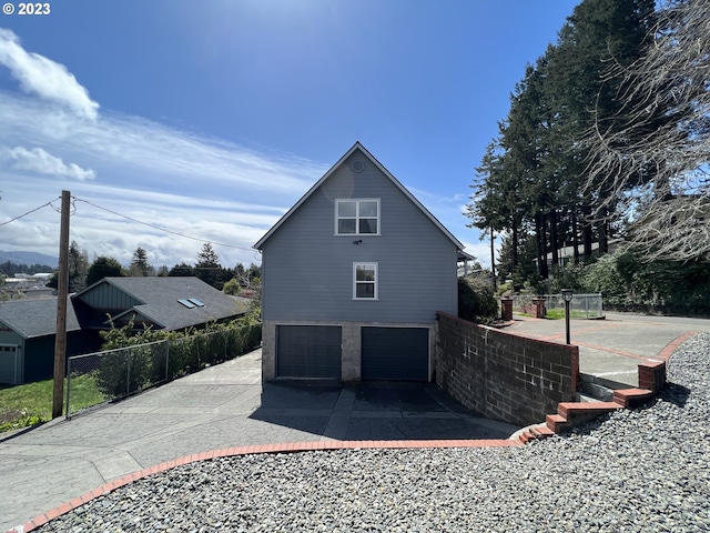 back of house featuring a garage