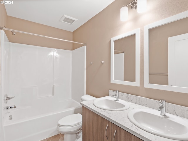 full bathroom featuring dual bowl vanity, tile flooring, toilet, and bathing tub / shower combination