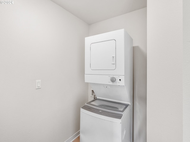 laundry room featuring stacked washer and clothes dryer