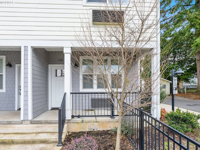 view of exterior entry with covered porch