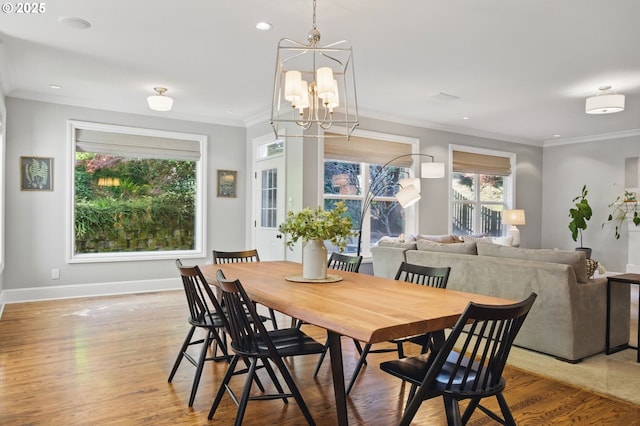 dining space with light wood-style floors, baseboards, recessed lighting, ornamental molding, and a chandelier