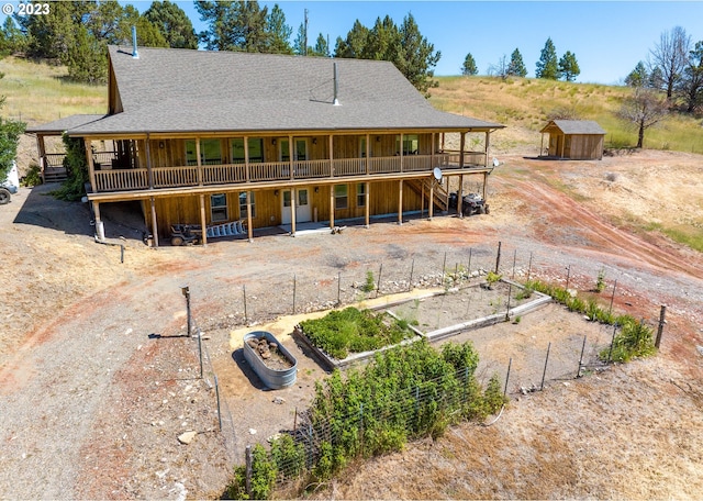 back of property featuring a storage shed