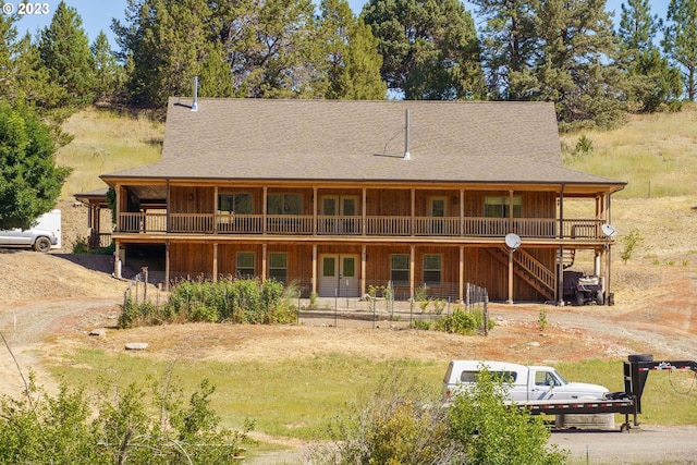 back of house featuring a balcony