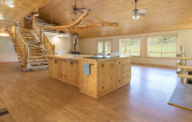 kitchen with ceiling fan, wood ceiling, an island with sink, and light hardwood / wood-style floors