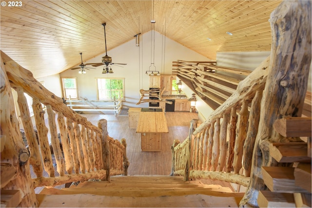 stairs featuring wooden ceiling, ceiling fan, lofted ceiling, and hardwood / wood-style flooring