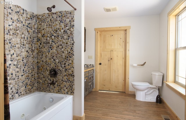 full bathroom featuring vanity, shower / tub combination, wood-type flooring, and toilet