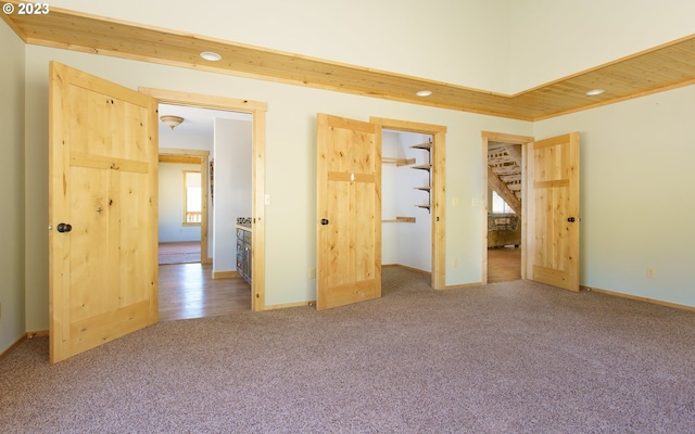 unfurnished bedroom featuring multiple windows and carpet floors