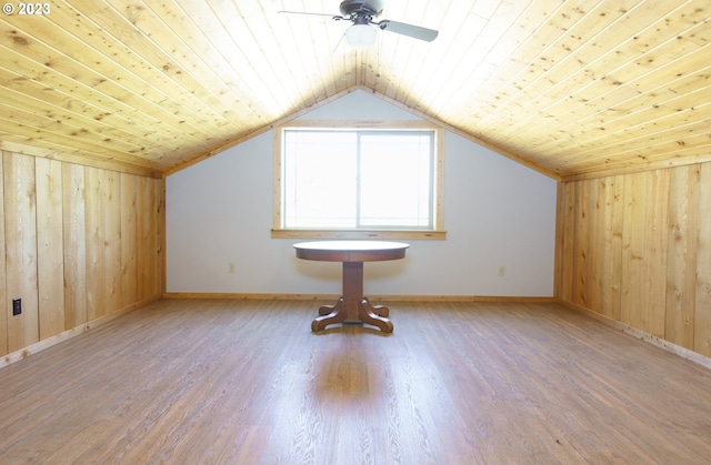 bonus room featuring wooden walls, wooden ceiling, and light hardwood / wood-style flooring