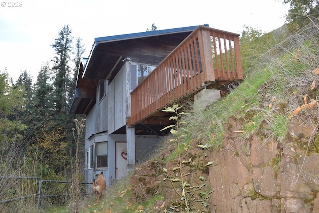 view of side of property with a wooden deck