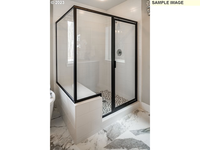 bathroom featuring tile floors and a shower with shower door