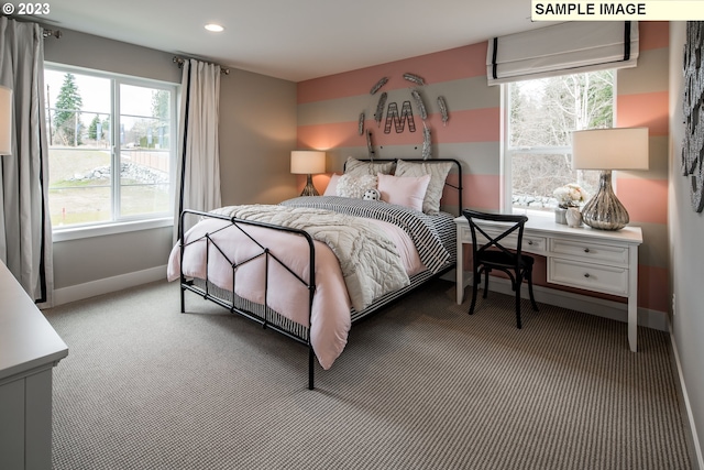 bedroom with light colored carpet and multiple windows