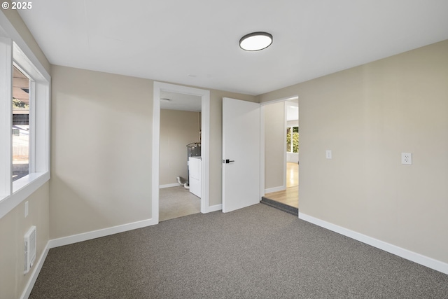 unfurnished bedroom with carpet, visible vents, and baseboards