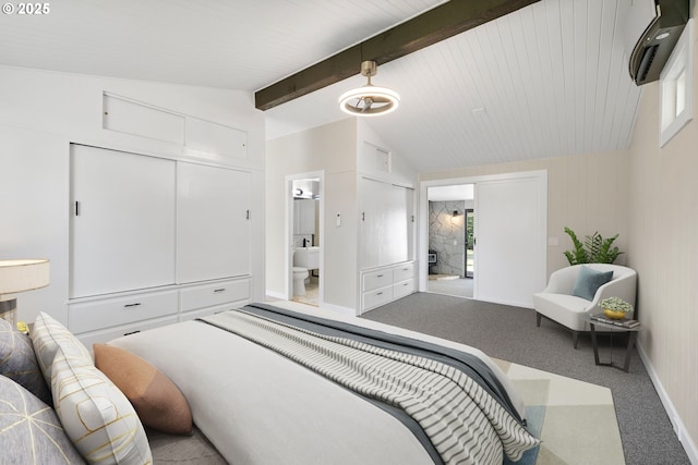 carpeted bedroom with lofted ceiling with beams, connected bathroom, and baseboards