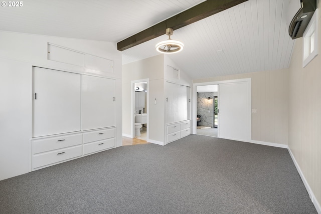 unfurnished bedroom with carpet floors, lofted ceiling with beams, baseboards, and connected bathroom