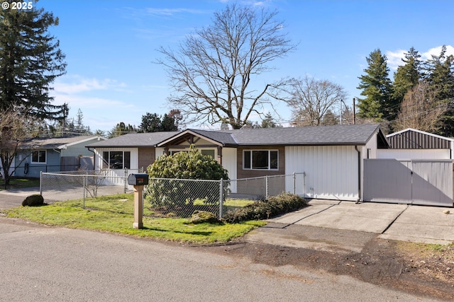 ranch-style home featuring a fenced front yard and a gate