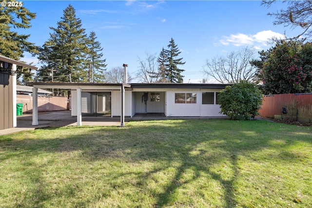 back of house featuring a patio, a yard, and fence private yard