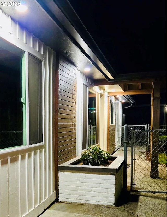 view of property exterior with a gate and brick siding