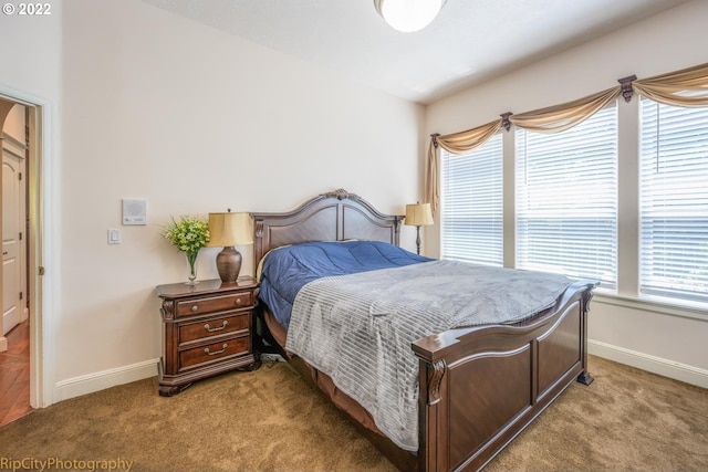 carpeted bedroom featuring multiple windows