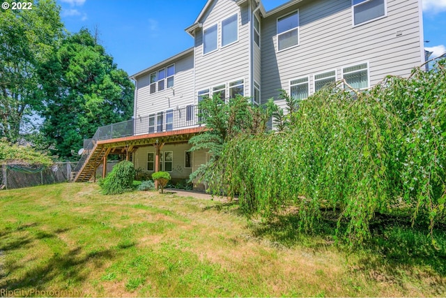 rear view of property featuring a yard